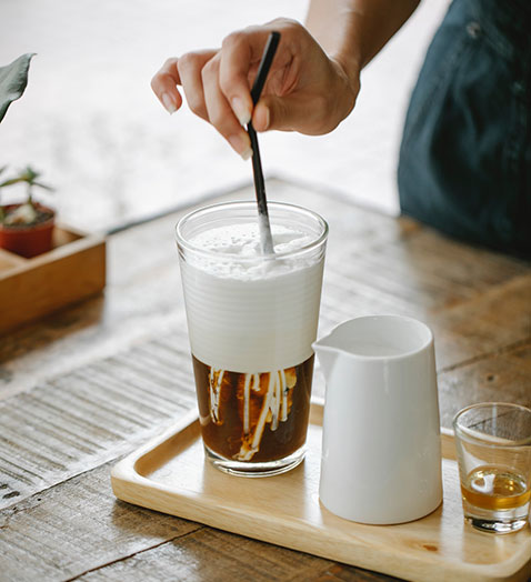 staff of cafe stirring coffee drink